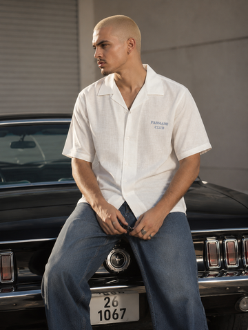 Man styling a premium white Cuban collar linen blend shirt for a smart-casual summer look